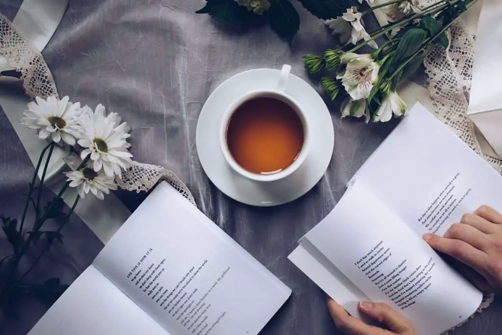 A cup of coffee and open poetry books