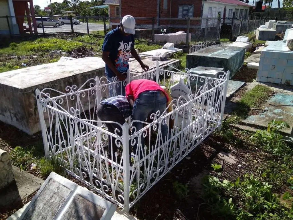 Men cleaning a grave site