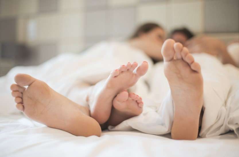 Lovers feet in bed