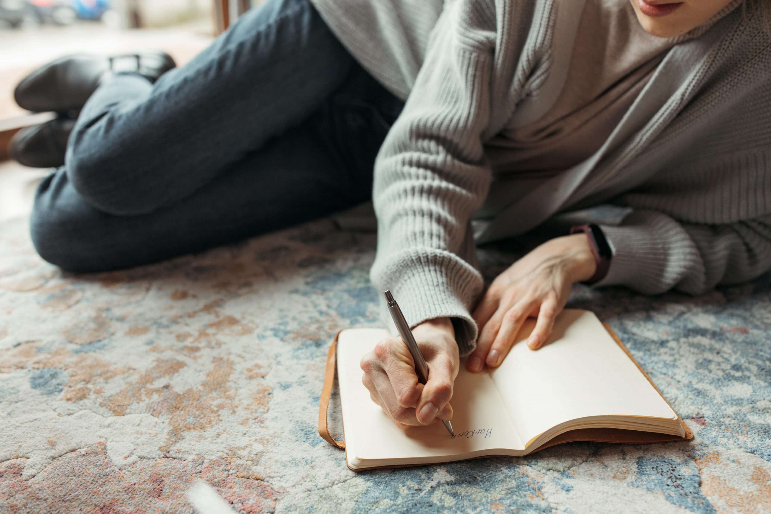 Girl writing poetry on the floor