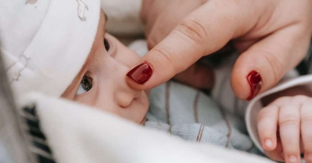 Mother touching baby nose